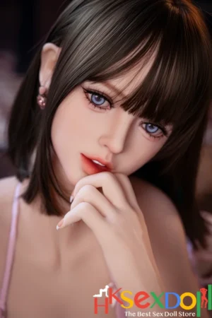 petite sex doll blonde hair pink stockings dark eyes warm background