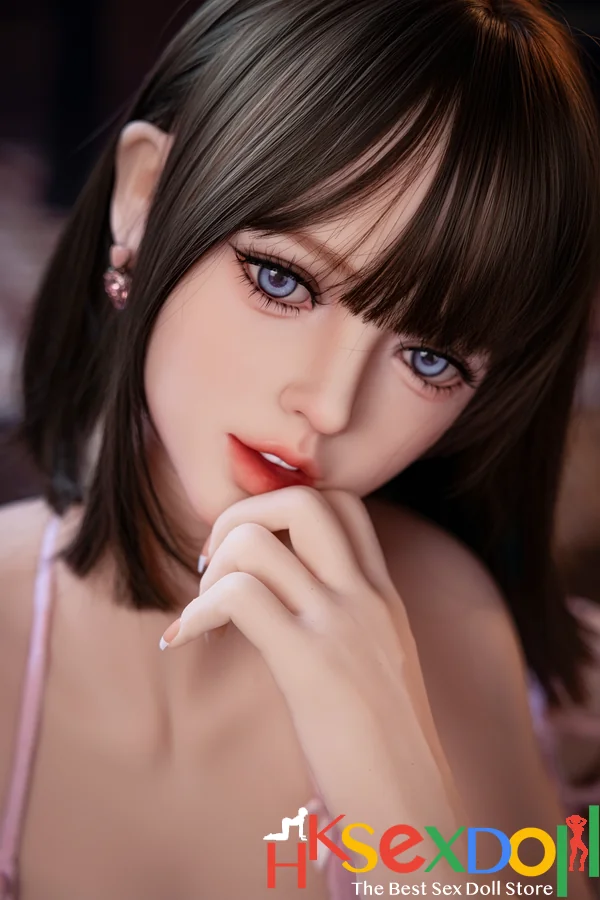 petite sex doll blonde hair pink stockings dark eyes warm background