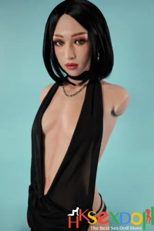 female torso sex doll with short black hair and a plunging black halter top, elegant pose